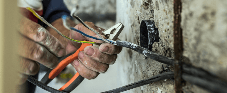 Man cutting electrical wires