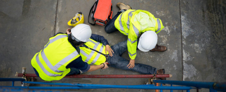 Builder injury accident falling scaffolding to the floor. Basic first aid training for support accident in site work, Safety team help employee accident.