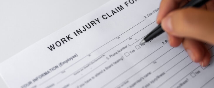 Woman filling Work Injury Claim Form