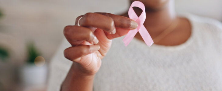 Breast cancer, pink ribbon and hands of black woman with symbol for awareness, testing and health check. Healthcare, medical care and girl holding bow, sign and icon for disease prevention or support
