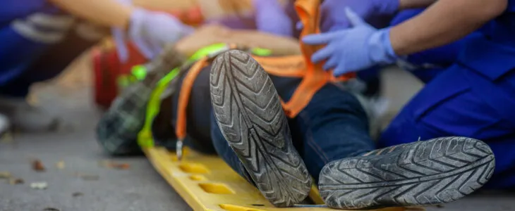 Selective focus shoe . Team paramedic firs aid accident on road. Ambulance emergency service. First aid procedure.