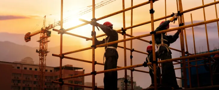 Group of construction workers working on scaffolding